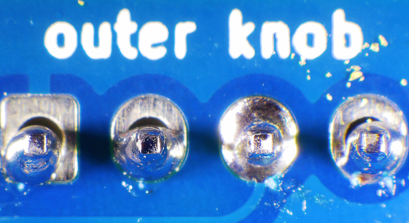 Photo of a board with four incorrectly soldered joints that lack enough solder to make a reliable connection.